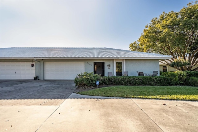 ranch-style house featuring a garage and a front yard