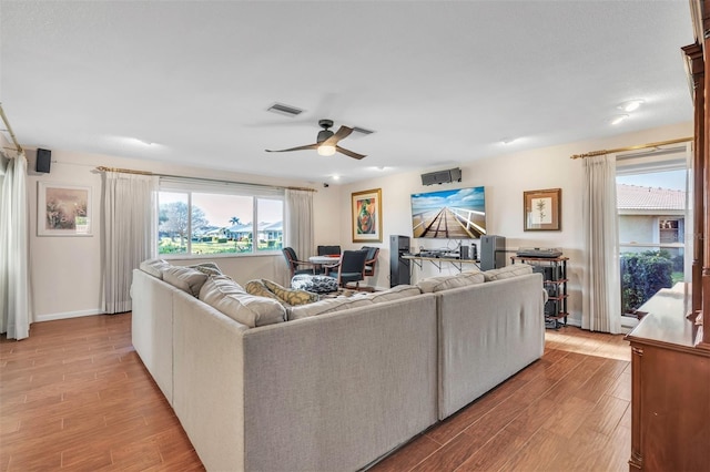 living room featuring light hardwood / wood-style floors, plenty of natural light, and ceiling fan