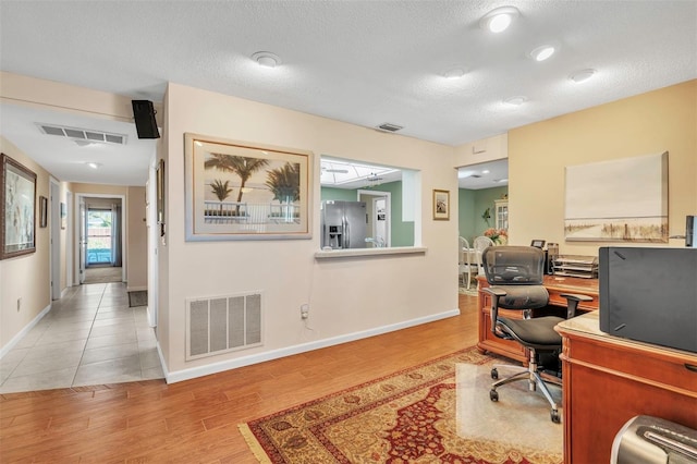 office area featuring tile patterned floors and a textured ceiling