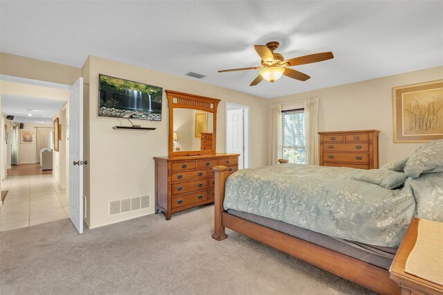 bedroom with light colored carpet and ceiling fan