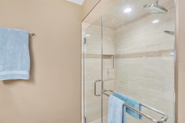 bathroom featuring a shower with door