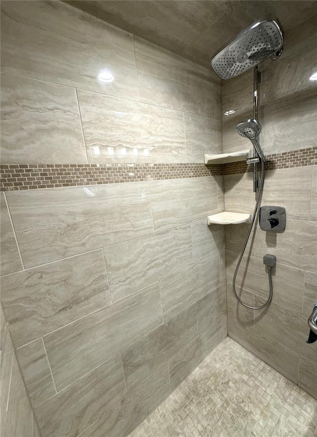 bathroom with a tile shower