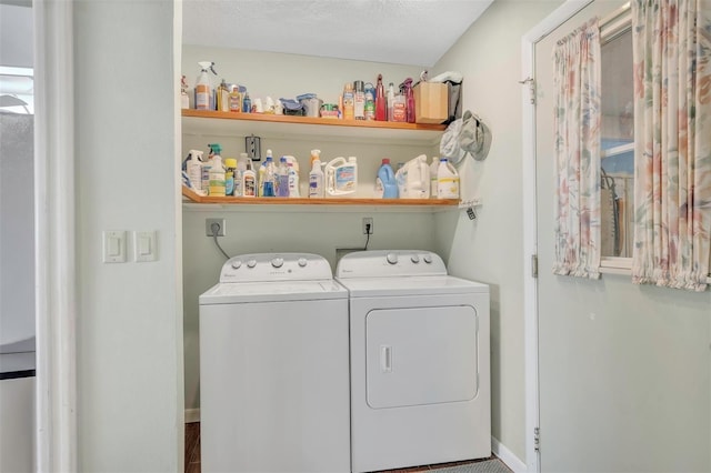 clothes washing area featuring a textured ceiling and separate washer and dryer