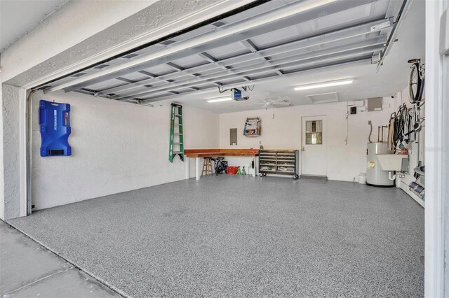 garage with electric panel, a garage door opener, and water heater