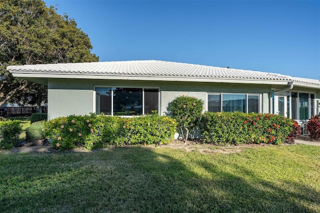 view of side of property with a yard