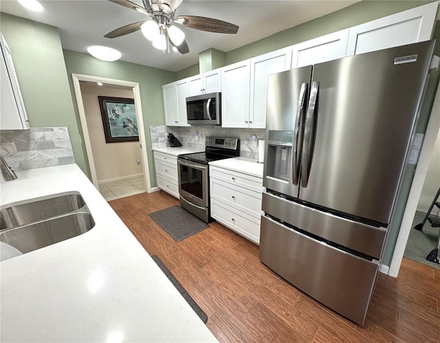 kitchen with white cabinetry, decorative backsplash, sink, and appliances with stainless steel finishes