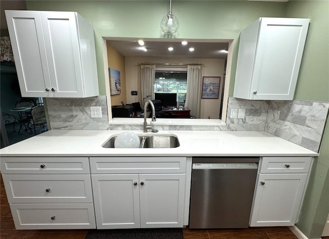 kitchen with dishwasher, tasteful backsplash, white cabinetry, and sink