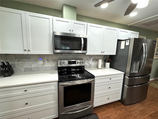 kitchen featuring ceiling fan, white cabinetry, stainless steel appliances, and tasteful backsplash