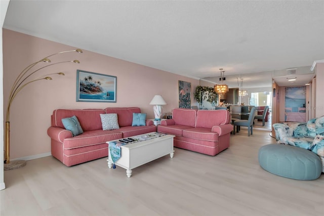 living room featuring light hardwood / wood-style floors and a notable chandelier