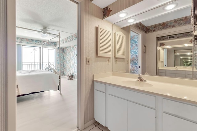 bathroom featuring tile floors, a textured ceiling, vanity, and ceiling fan