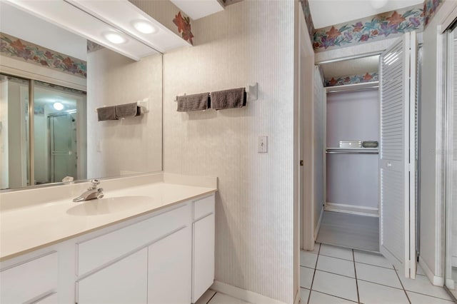 bathroom featuring tile floors and vanity with extensive cabinet space