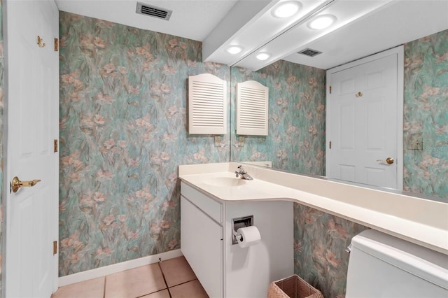 bathroom featuring toilet, tile floors, and vanity