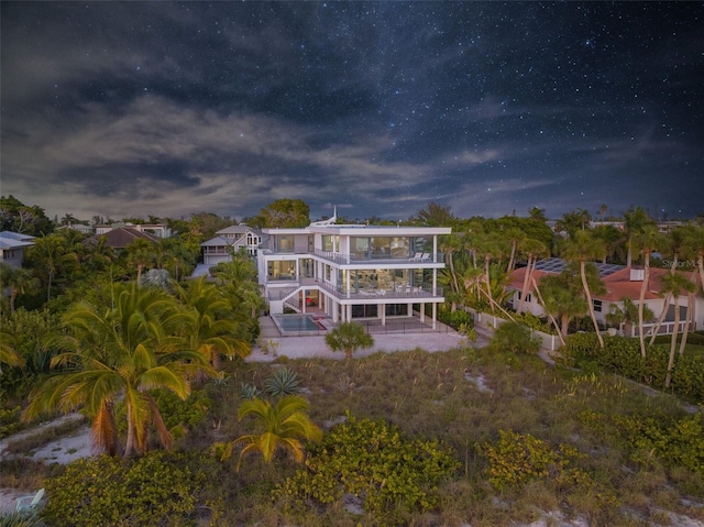 rear view of property featuring a patio area and a balcony