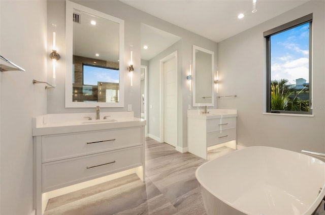 bathroom featuring a bathing tub and vanity