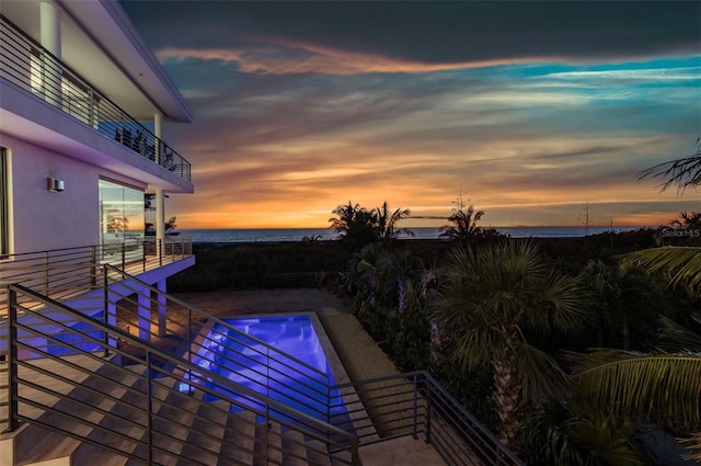 pool at dusk with a water view