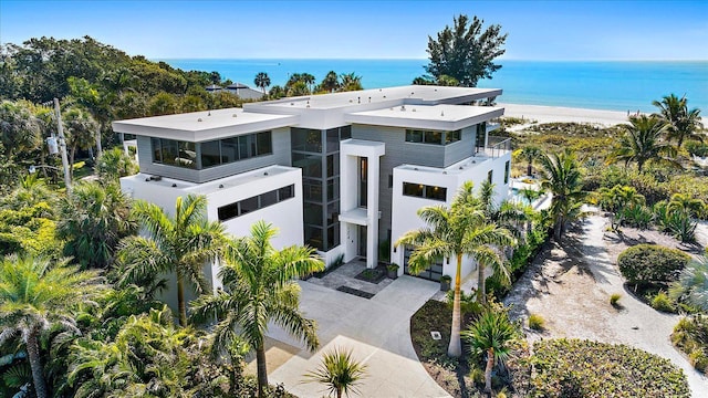 view of front of property featuring a water view and a beach view