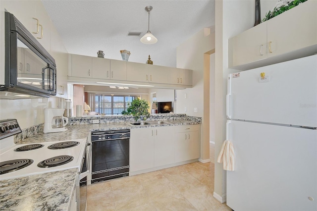 kitchen with hanging light fixtures, light stone countertops, a textured ceiling, black appliances, and light tile floors