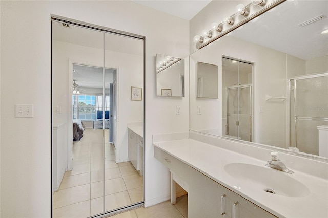 bathroom with tile flooring, ceiling fan, and vanity