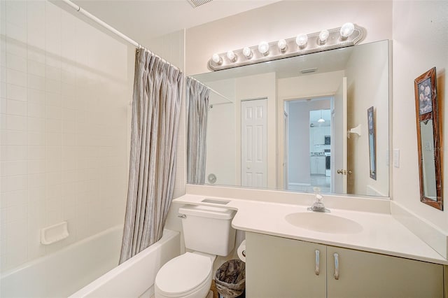 full bathroom featuring shower / bath combination with curtain, toilet, and vanity with extensive cabinet space