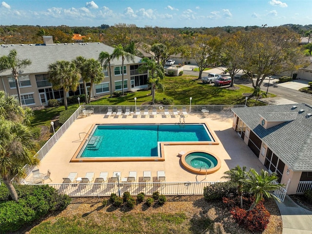 view of swimming pool with a hot tub and a patio