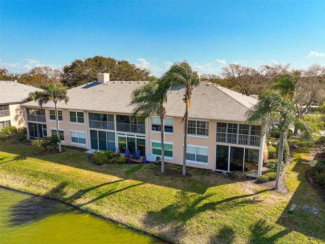 rear view of property with a lawn