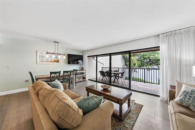 living room featuring a notable chandelier and light hardwood / wood-style flooring