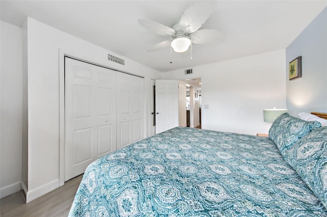 bedroom featuring a closet, ceiling fan, and light hardwood / wood-style flooring