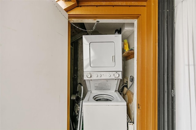 clothes washing area with stacked washer / drying machine