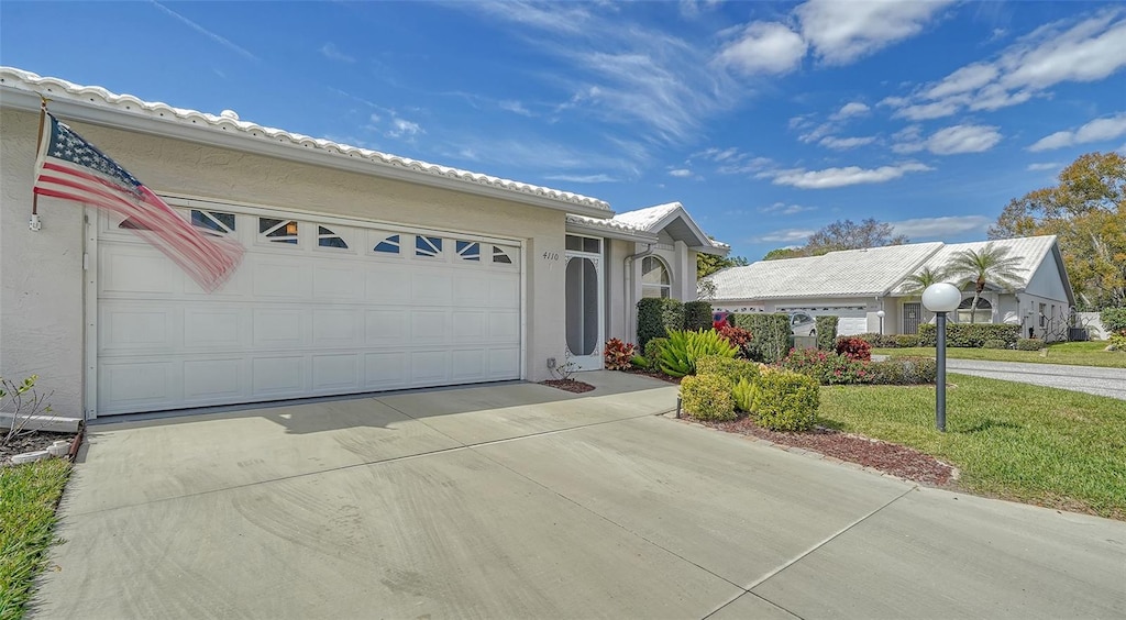 view of front of house with a front yard and a garage