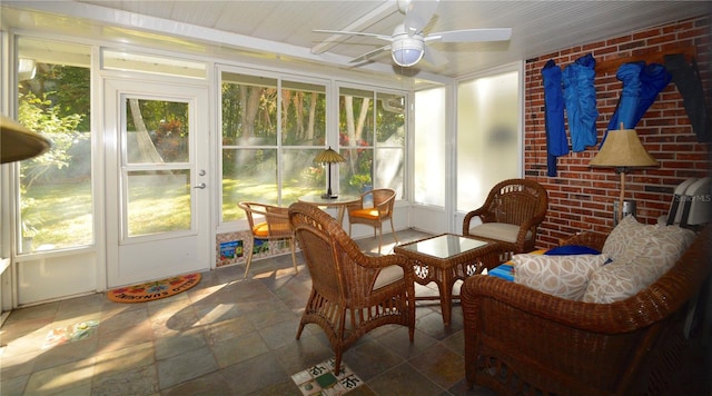 sunroom featuring ceiling fan and a healthy amount of sunlight