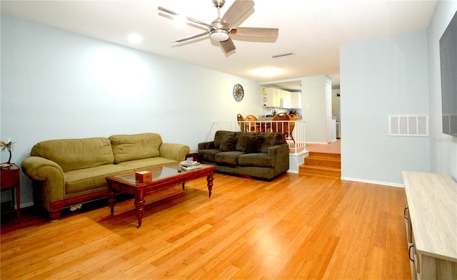 living room featuring light wood-type flooring and ceiling fan