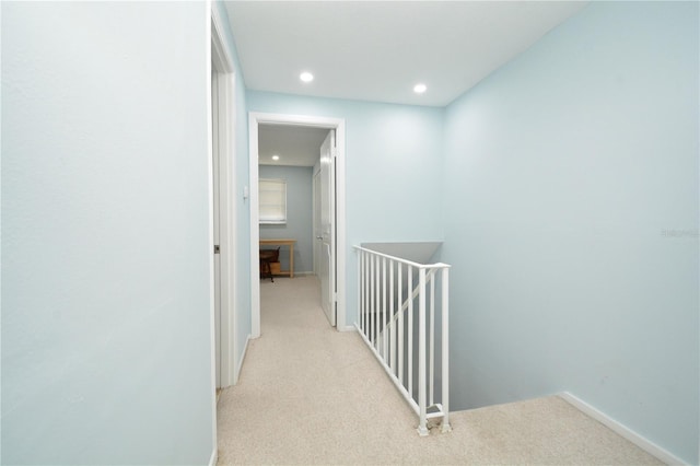 hallway featuring light colored carpet