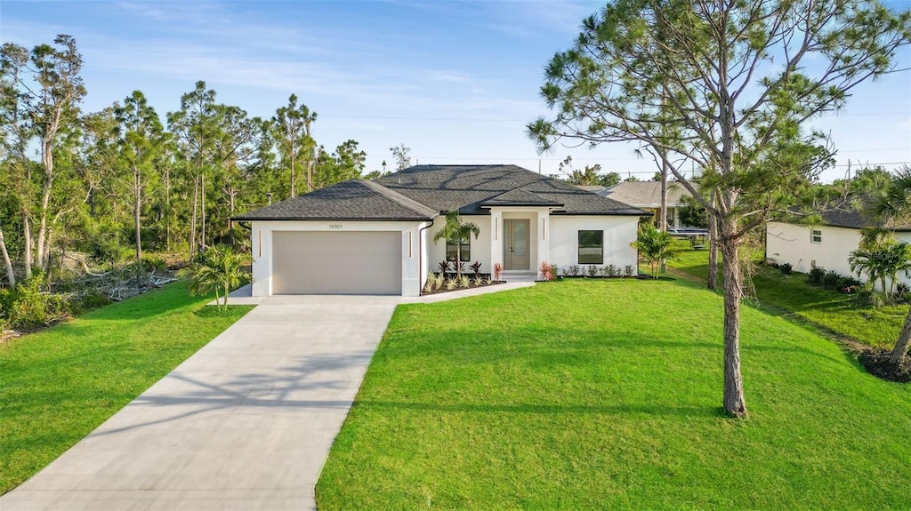 view of front of property with a garage and a front lawn