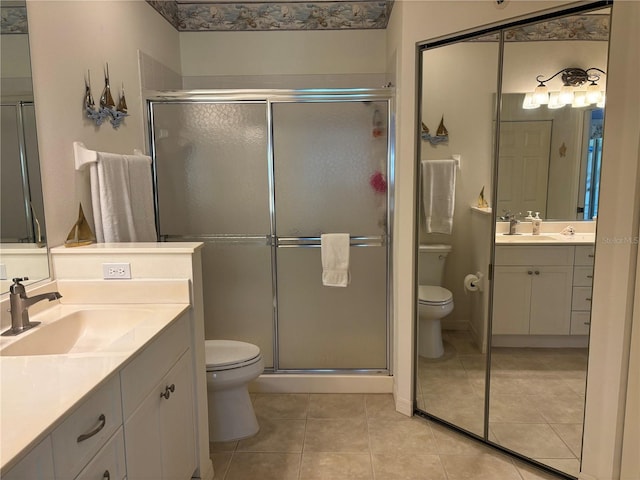 bathroom with walk in shower, tile flooring, oversized vanity, and toilet