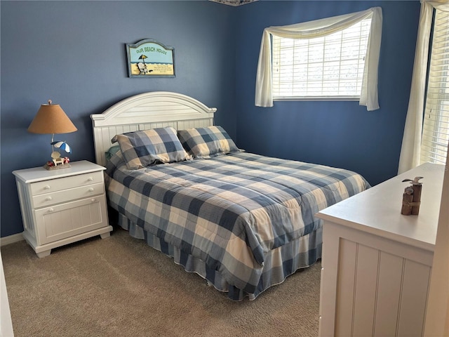 bedroom featuring dark carpet