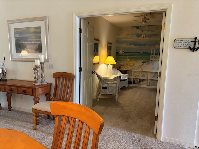 living area featuring light carpet and ceiling fan