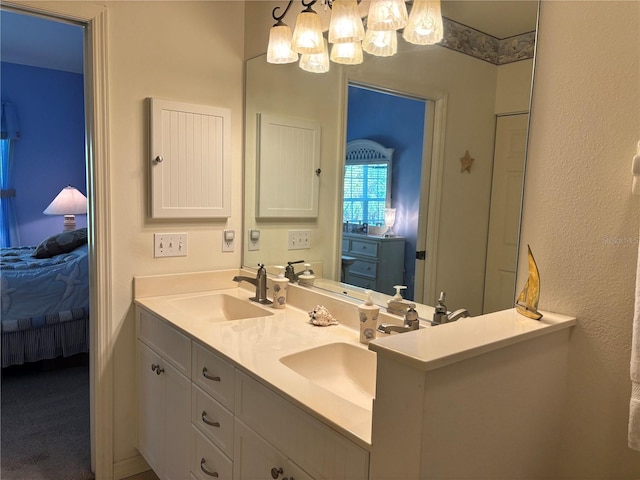 bathroom with double vanity and an inviting chandelier