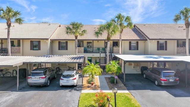 multi unit property featuring a balcony and a carport