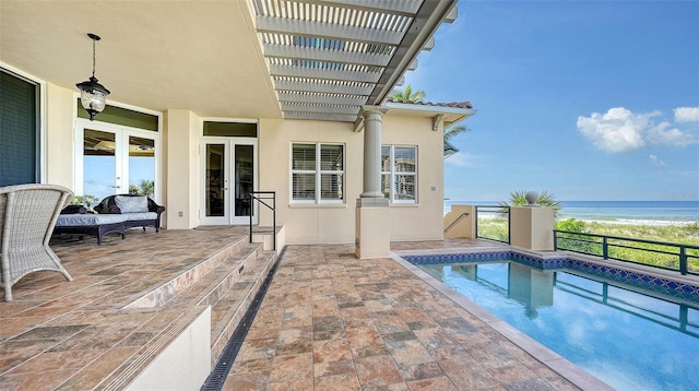 view of pool featuring a patio, a pergola, and a water view