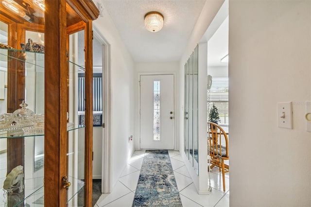 entrance foyer featuring light tile patterned flooring and a textured ceiling