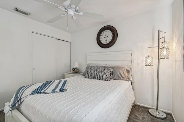 bedroom with ceiling fan, carpet floors, and a closet