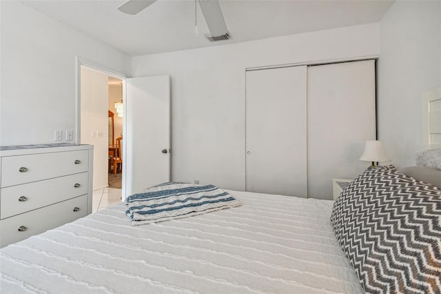 carpeted bedroom featuring ceiling fan and a closet