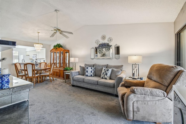 living room featuring lofted ceiling, carpet flooring, a textured ceiling, and ceiling fan with notable chandelier