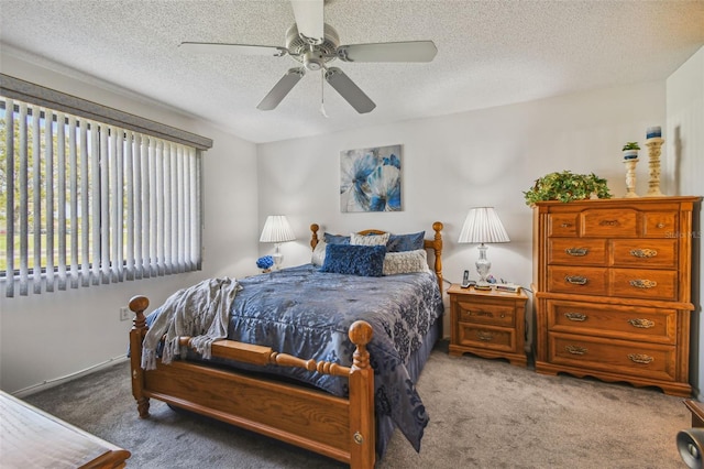 carpeted bedroom with ceiling fan and a textured ceiling