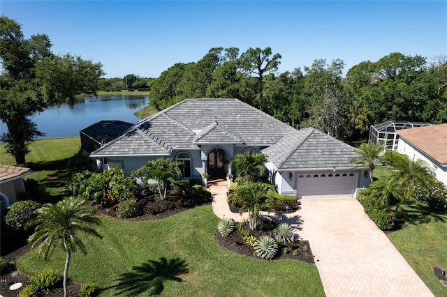 view of front of home featuring a water view, a front yard, and a garage