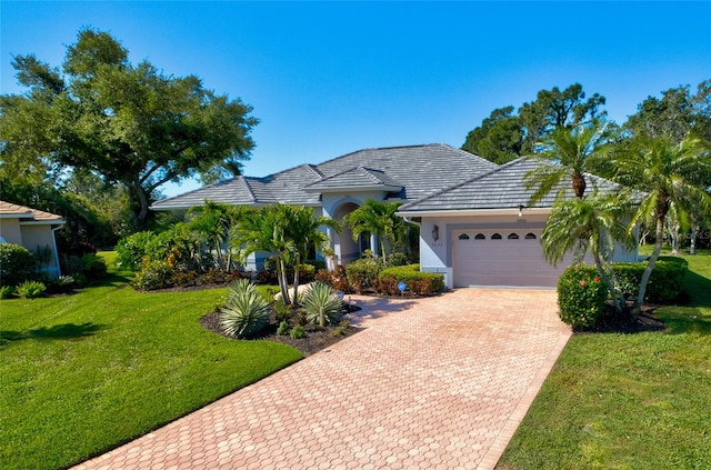 view of front facade featuring a front lawn and a garage