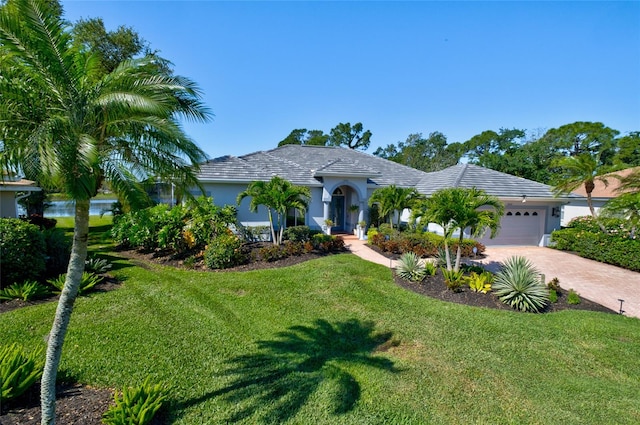 view of front of house with a front lawn and a garage