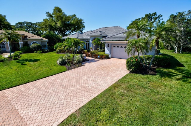 view of front of home with a front yard and a garage