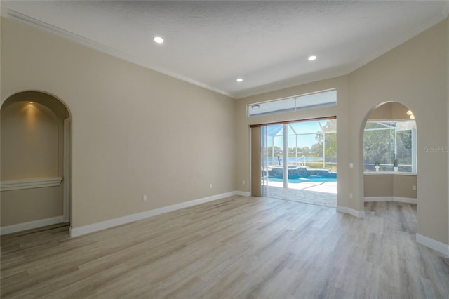 unfurnished room featuring crown molding and light hardwood / wood-style floors