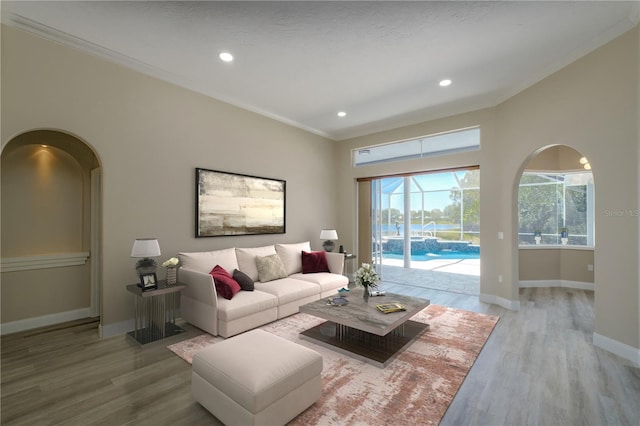 living room with crown molding and light hardwood / wood-style flooring